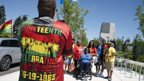 The Scott and Holleman families, who are visiting from Colorado and Nebraska, respectively, take a photo on Juneteenth at the Obama Presidential Center on the South Side, Friday, June 19, 2026.