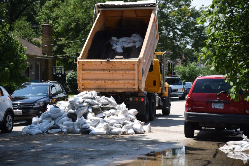 A dump truck drops off another load of sandbags on La Fox River Drive in Algonquin Thursday. | Rick West/Daily Herald
