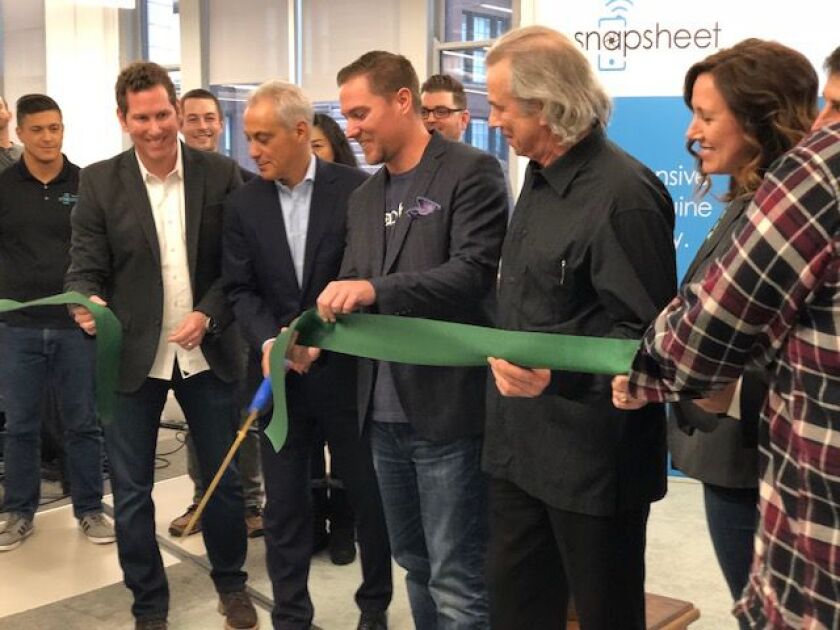 Mayor Rahm Emanuel cuts a ribbon Tuesday to celebrate the opening of Snapsheet’s new headquarters at 1 N. Dearborn. The company pioneered virtual claims technology for the personal and commercial and insurance industries. (Photo by Fran Spielman).