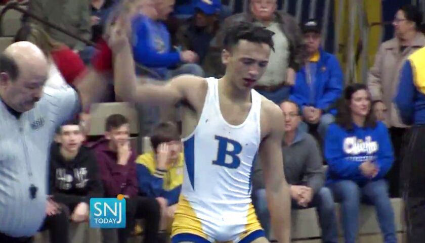 In this image taken from a Wednesday, Dec. 19, 2018 video provided by SNJTODAY.COM, Buena Regional High School wrestler Andrew Johnson is declared the winner after his match in in Buena, N.J. Before the match a referee told Johnson he would forfeit his bo