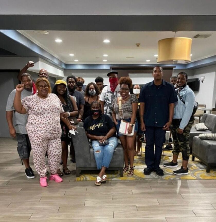 On a mission to deliver supplies to New Orleans, the Chicago-based Journey For Justice group learned of the plight of some dozen New Orleans families who had evacuated from Hurricane Ida and faced eviction from their hotel after running out of money. J4J paid hotel bills for all, through the weekend. Some of those families are pictured here.