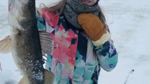 Dana Kolzow with her dog Hanna and their 25-inch walleye. Provided by Kurt’s Island Sportshop
