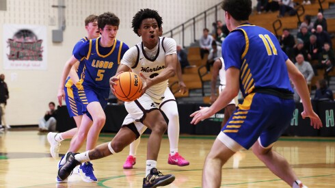 Perspectives-Leadership's Morgan Travis (2) uses a ball fake to open the lane for a drive at York's Jack Tosh Holiday Classic