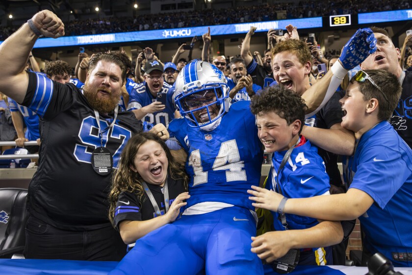 Detroit Lions wide receiver Amon-Ra St. Brown #14 jumps into the stands to celebrate a touchdown during the fourth quarter against the Chicago Bears at Ford Field, Sunday, Sept. 14, 2025. The Lions beat the Bears, 52 - 21.