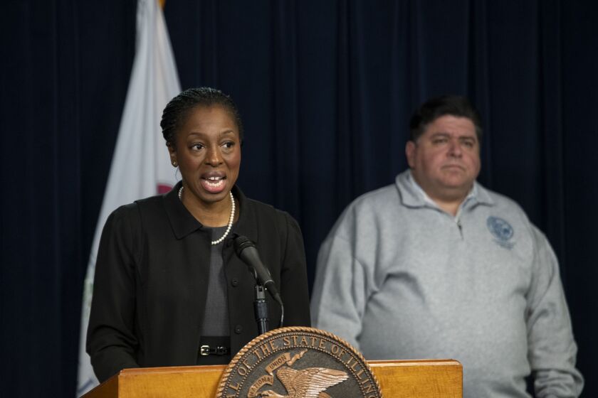 Illinois Public Health Director Dr. Ngozi Ezike speaks alongside Gov. J.B. Pritzker at a March 19 news briefing.
