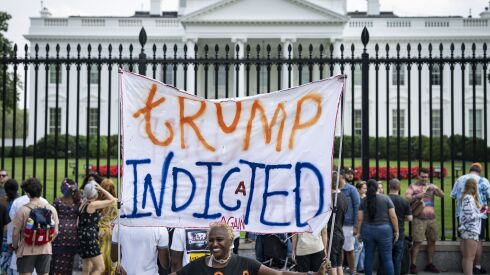 Nadine Seiler, of Waldorf, Maryland, demonstrates in front of the White House after Special Counsel Jack Smith delivered remarks about the unsealed federal indictment against former President Donald Trump on Friday.