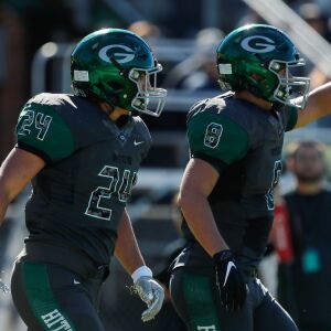 Glenbard West’s Nic Seifert (24) walks back to his team with Denin Limouris (8) after scoring a touchdown against Hinsdale Central.