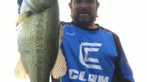 Ken “Husker” O’Malley with a largemouth bass from the Des Plaines River. Provided photo