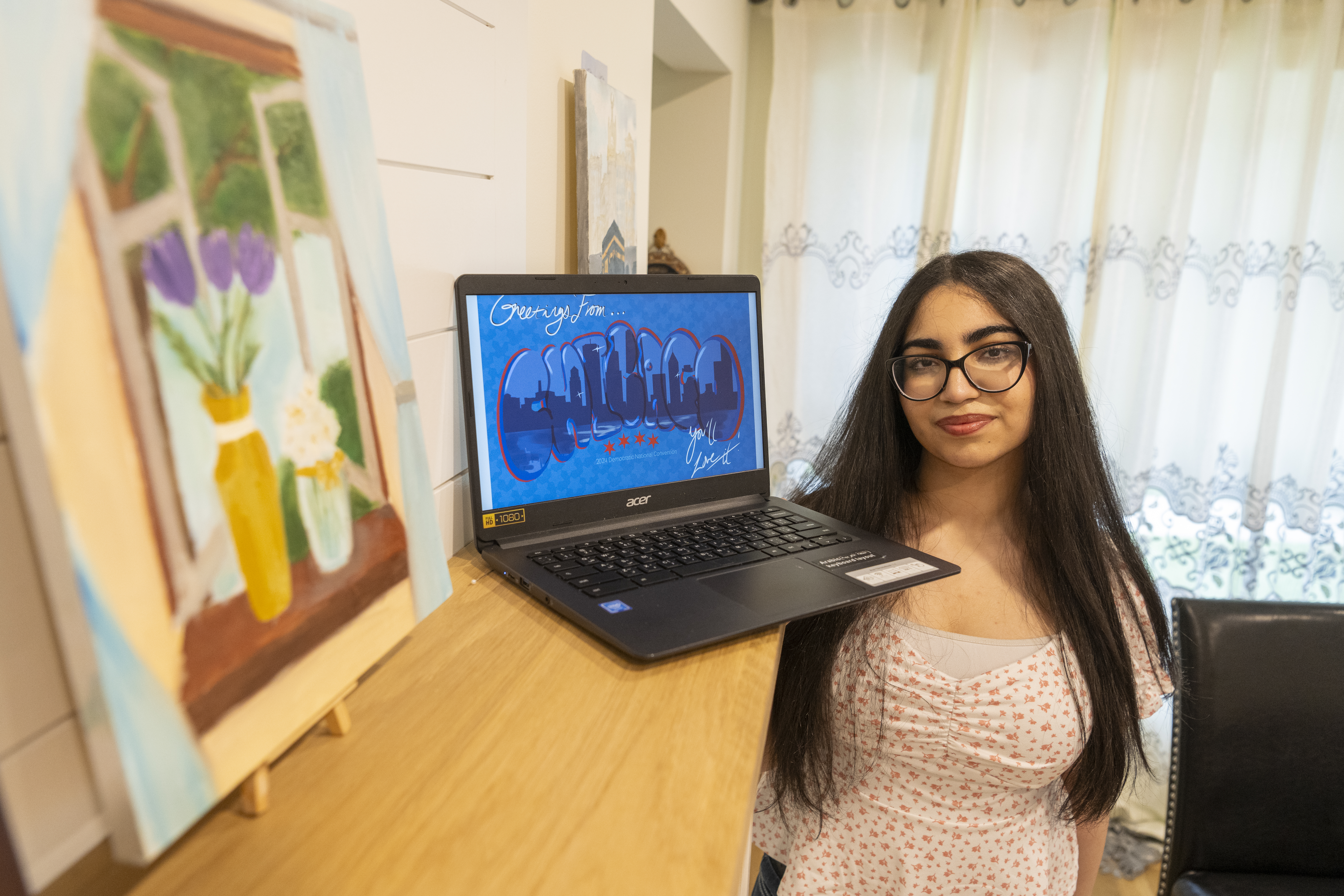 Sarah Al-Shawabkeh, 16, a junior at William Howard Taft High School, displays a copy of her work that won the “Welcome to Chicago” High School Art. Al-Shawabkeh will have her design featured on official Democratic National Convention memorabilia.