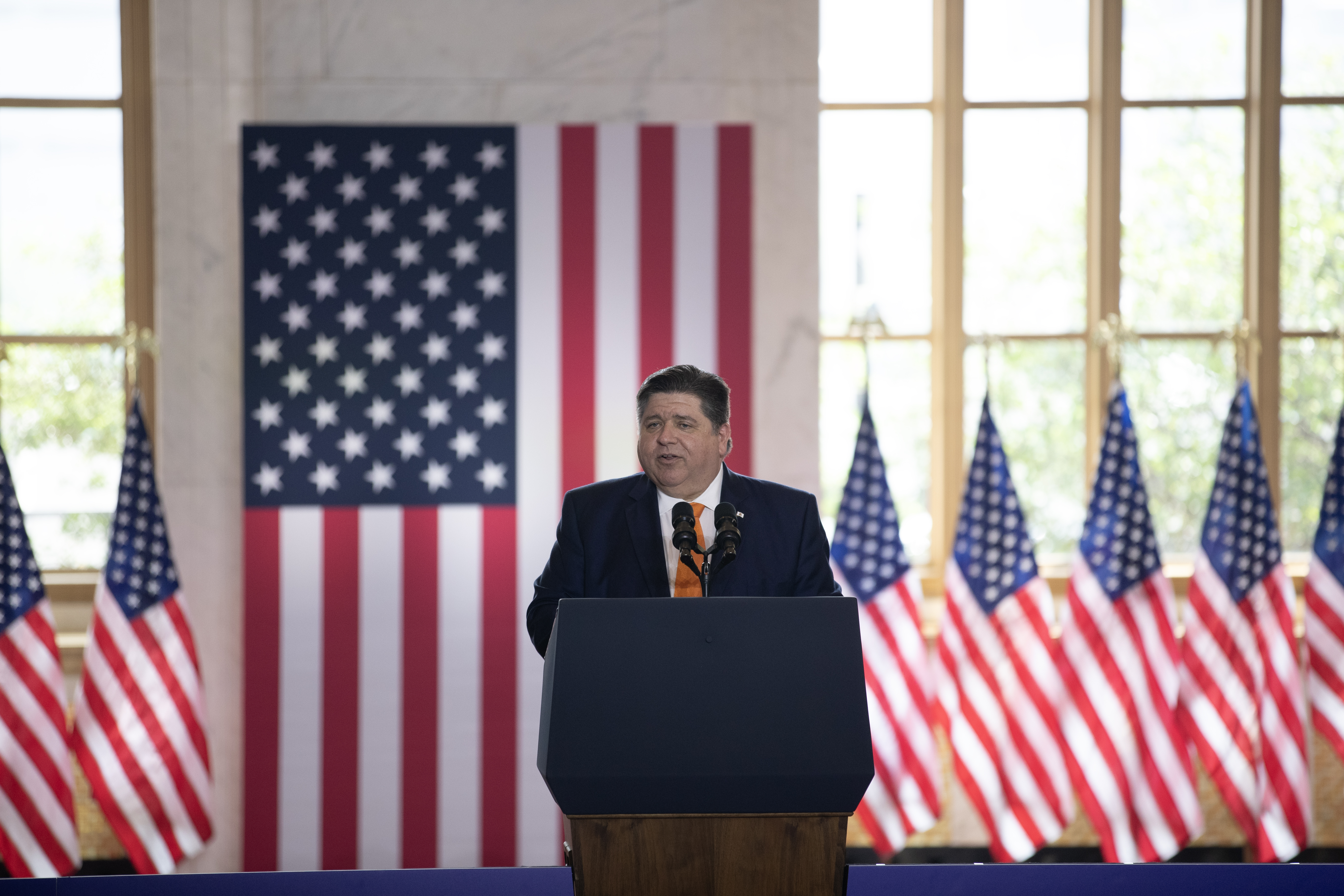 Gov. J.B. Pritzker at the podium before President Joe Biden delivers a speech at The Old Post Office on June 28, 2023 in Chicago.