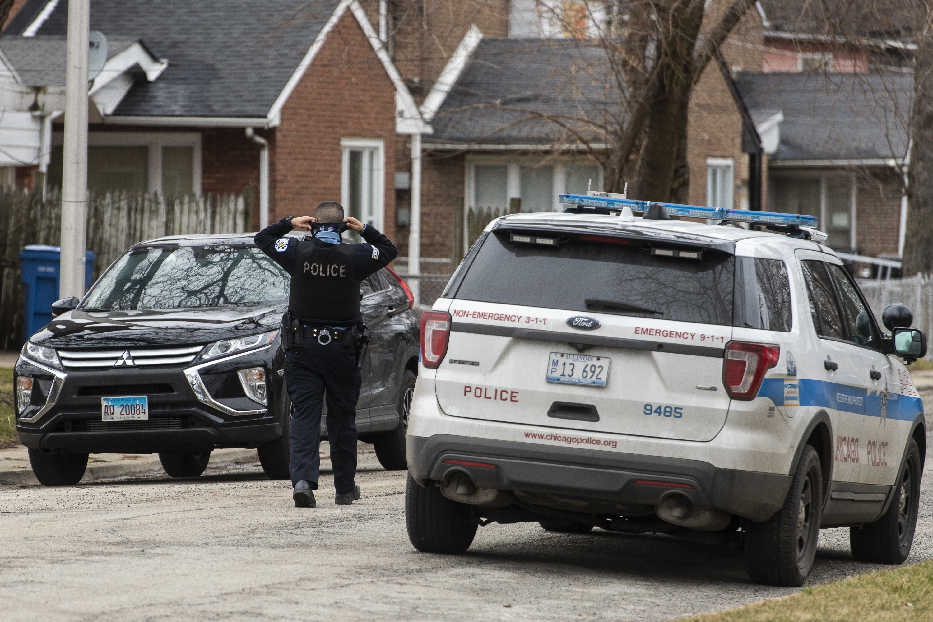 A Chicago police officer approaches at car in the 9200 block of South Williams Avenue.